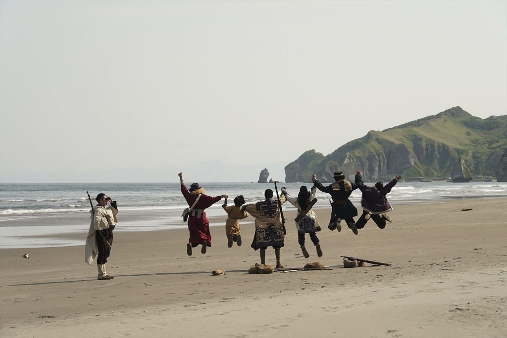 Les personnages sautant dans les airs devant la mer